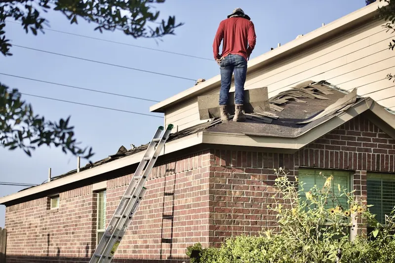 Professional roofer working on a residential roof in Constitution Place